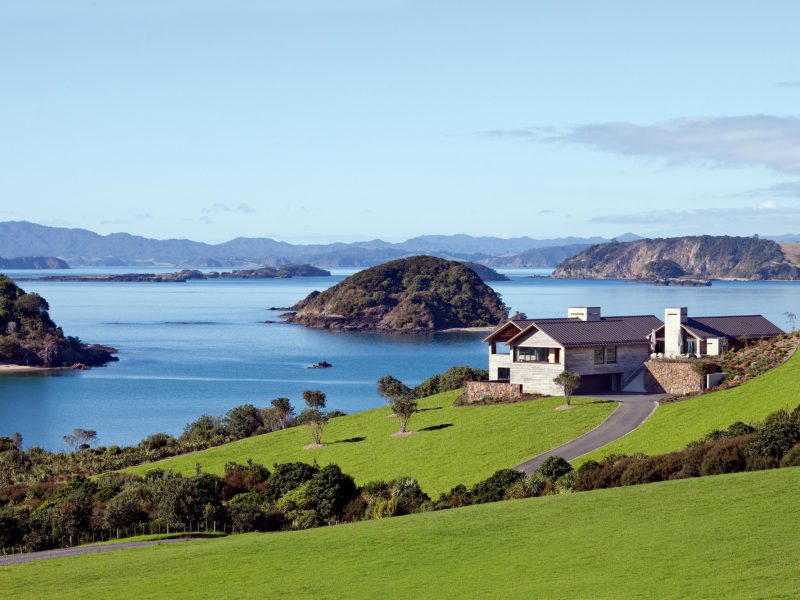 View of The Landing with rolling green grounds and the Bay of Islands in the background